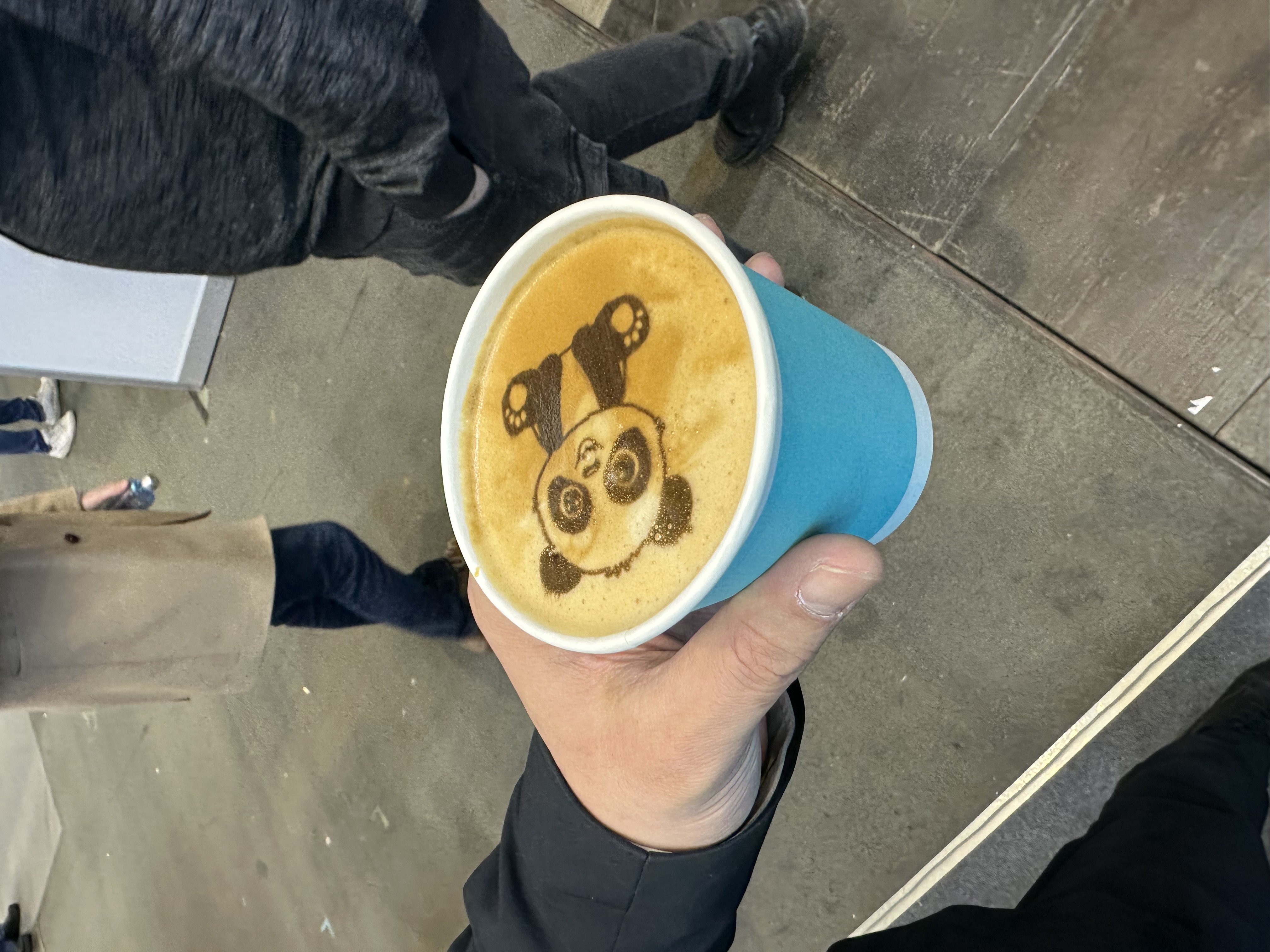 Panda illustration printed onto coffee foam.